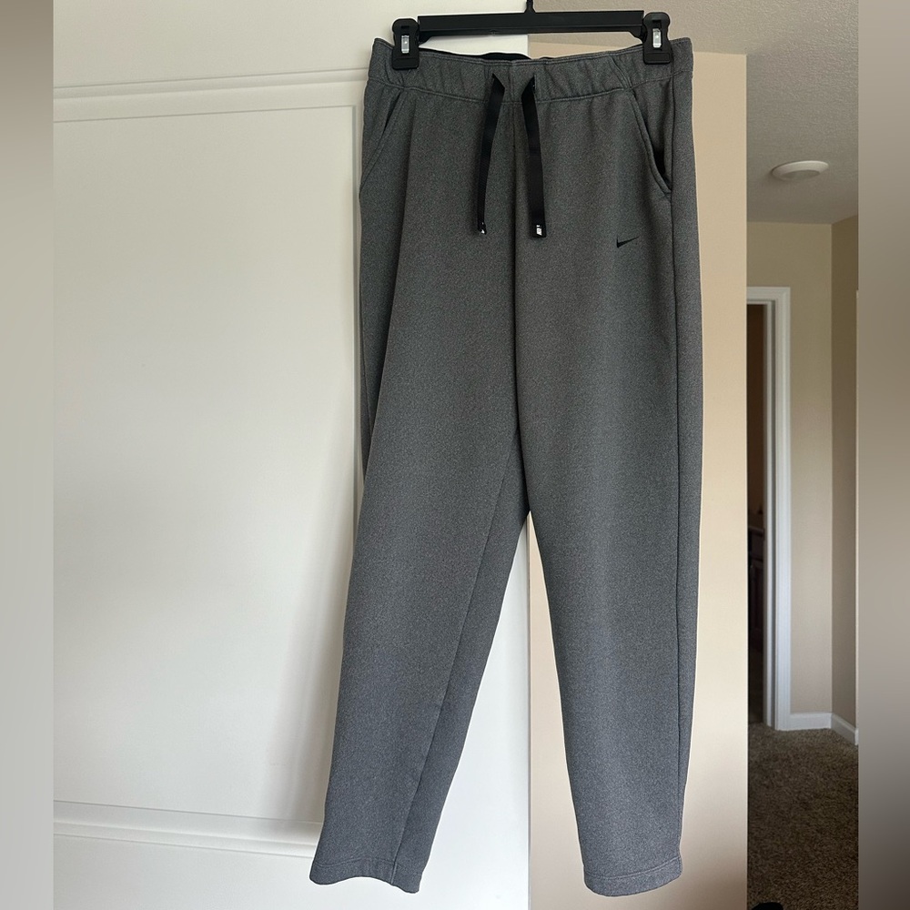 Nike straight leg grey fleece lined sweatpants. Zippers on bottom of legs.
